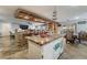 Stylish kitchen showcasing granite countertops, island seating, and an open layout to the living areas at 8354 Woodland Prairie Ave, Las Vegas, NV 89129
