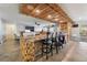 Open concept living room with custom wood bar, tile flooring, and patio access at 8354 Woodland Prairie Ave, Las Vegas, NV 89129