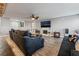 Bright living room with a ceiling fan, fireplace, and multiple couches at 8354 Woodland Prairie Ave, Las Vegas, NV 89129