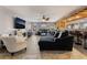 Open-concept living room featuring a large sofa, fireplace and bar area perfect for entertaining at 8354 Woodland Prairie Ave, Las Vegas, NV 89129