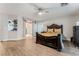 This spacious main bedroom boasts a luxury bed, an ensuite bathroom, and hardwood floors at 8354 Woodland Prairie Ave, Las Vegas, NV 89129