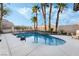 Backyard pool with palm trees and rock features at 8354 Woodland Prairie Ave, Las Vegas, NV 89129