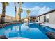 Backyard pool area with a covered patio and green landscaping at 8354 Woodland Prairie Ave, Las Vegas, NV 89129