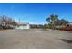 Vast backyard showcasing a detached garage with a tile roof, offering versatility for landscaping or outdoor features at 8365 Haven St, Las Vegas, NV 89123