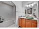 Bright bathroom offering a tub, single sink vanity, and neutral decor at 8365 Haven St, Las Vegas, NV 89123