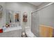 Charming bathroom featuring a shower with glass door, vanity with granite countertop, and woven wall storage at 8365 Haven St, Las Vegas, NV 89123