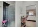 Updated bathroom with a modern glass-enclosed shower and shelving, connecting to the bedroom at 8365 Haven St, Las Vegas, NV 89123