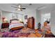 Charming bedroom featuring decorative carpet, a ceiling fan, and ensuite bathroom at 8365 Haven St, Las Vegas, NV 89123