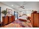 Cozy bedroom with stylish carpet, a ceiling fan, and views of the landscaped yard at 8365 Haven St, Las Vegas, NV 89123