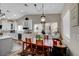 Open-concept kitchen and dining area with white cabinets, modern appliances, and a wood dining table at 8365 Haven St, Las Vegas, NV 89123