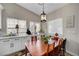 Bright dining area with a wood table, chairs, built-in cabinets, and natural light from windows at 8365 Haven St, Las Vegas, NV 89123