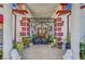 The home's grand gated entry, adorned with plants and stone columns at 8365 Haven St, Las Vegas, NV 89123