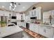 Modern kitchen boasts white cabinets, stainless appliances, stone backsplash, and stylish pendant lighting at 8365 Haven St, Las Vegas, NV 89123