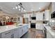 Spacious kitchen features white cabinetry, stainless steel appliances, and a large island with a sink at 8365 Haven St, Las Vegas, NV 89123