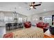 Open-concept living room and kitchen area, featuring modern lighting and a breakfast bar at 8365 Haven St, Las Vegas, NV 89123