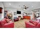 Comfortable living room featuring red sofas, a ceiling fan, recessed lighting, and a view of the kitchen at 8365 Haven St, Las Vegas, NV 89123