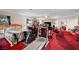 Spacious living room with exercise equipment, ample seating and bright lighting at 8365 Haven St, Las Vegas, NV 89123