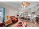 Cozy living room with comfortable seating, a ceiling fan, and large windows at 8365 Haven St, Las Vegas, NV 89123