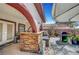 Backyard outdoor kitchen with stone bar, patio area, covered seating, barbecue, and dining area, perfect for outdoor living at 8365 Haven St, Las Vegas, NV 89123