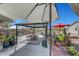 Backyard scene showcasing an outdoor patio with a gazebo, plants, lounge, and an umbrella for shaded relaxation at 8365 Haven St, Las Vegas, NV 89123