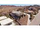 Aerial view of a hillside home with a balcony overlooking desert landscape and neighborhood at 879 Judi Pl, Boulder City, NV 89005