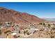 Aerial view of homes in desert landscape with large mountain and lake in the background at 879 Judi Pl, Boulder City, NV 89005