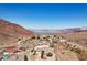 Aerial view of homes in a desert community with mountain and lake views at 879 Judi Pl, Boulder City, NV 89005