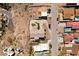 Aerial view of desert homes, one with a circular driveway, landscaping, and a swimming pool at 879 Judi Pl, Boulder City, NV 89005