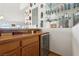 Wet bar area with custom wood cabinetry, display shelving, and beverage refrigeration at 879 Judi Pl, Boulder City, NV 89005