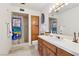 Bathroom featuring tiled shower, wood cabinets, nautical themed shower curtain and decor, with ample counter space at 879 Judi Pl, Boulder City, NV 89005