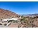 Scenic patio view of hillside homes in a desert community with mountain and lake backdrop at 879 Judi Pl, Boulder City, NV 89005