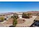 Hillside home with a circular driveway, garage, lush trees, and lake views at 879 Judi Pl, Boulder City, NV 89005