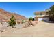 This hillside home features a long driveway and well-manicured landscaping, offering curb appeal at 879 Judi Pl, Boulder City, NV 89005