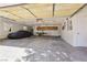Spacious garage with shelving, work bench, storage and covered car featuring natural light from the window at 879 Judi Pl, Boulder City, NV 89005