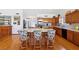 Kitchen featuring bar stool seating at the island with lots of wood cabinets and lighting at 879 Judi Pl, Boulder City, NV 89005