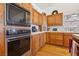 Well-maintained kitchen featuring wood cabinets, vintage oven appliances, and tile countertops at 879 Judi Pl, Boulder City, NV 89005