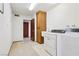 Bright laundry room features washer, dryer, utility sink, and convenient built-in storage cabinets at 879 Judi Pl, Boulder City, NV 89005