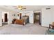 This spacious main bedroom features wall to wall carpeting, light walls, wood trim and a doorway at 879 Judi Pl, Boulder City, NV 89005