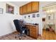 This home office features an executive desk, storage cabinets and view into the bathroom at 879 Judi Pl, Boulder City, NV 89005