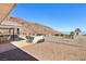 Entertain in this outdoor space featuring an outdoor kitchen, mountain views, and ample seating area at 879 Judi Pl, Boulder City, NV 89005