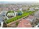 Community aerial view featuring green spaces, including a basketball court, playground, and lush landscaping at 8944 Skye Canyon Ranch St, Las Vegas, NV 89166