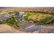 Aerial view of a community featuring a park, basketball court, playground, and numerous homes at 8944 Skye Canyon Ranch St, Las Vegas, NV 89166