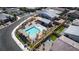 Aerial view of community pool with lounge chairs, pool house and nearby outdoor amenities at 8944 Skye Canyon Ranch St, Las Vegas, NV 89166