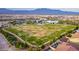 Aerial view of community park featuring green spaces, playground, and mature trees at 8944 Skye Canyon Ranch St, Las Vegas, NV 89166