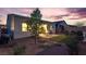 Landscaped backyard with patio, small decorative trees, and artificial turf at 8944 Skye Canyon Ranch St, Las Vegas, NV 89166