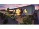 Landscaped backyard with patio, small decorative trees, and artificial turf at 8944 Skye Canyon Ranch St, Las Vegas, NV 89166
