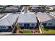 Aerial view of a modern home, highlighting the well-maintained backyard with patio area and green artificial turf at 8944 Skye Canyon Ranch St, Las Vegas, NV 89166