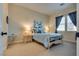 Cozy bedroom with blue accents, plush carpet, and ample natural light at 8944 Skye Canyon Ranch St, Las Vegas, NV 89166