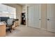 Neutral bedroom with a large window, closet, and workspace at 8944 Skye Canyon Ranch St, Las Vegas, NV 89166