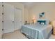 Comfortable bedroom featuring carpet flooring, neutral walls, and a Queen bed with blue covers at 8944 Skye Canyon Ranch St, Las Vegas, NV 89166